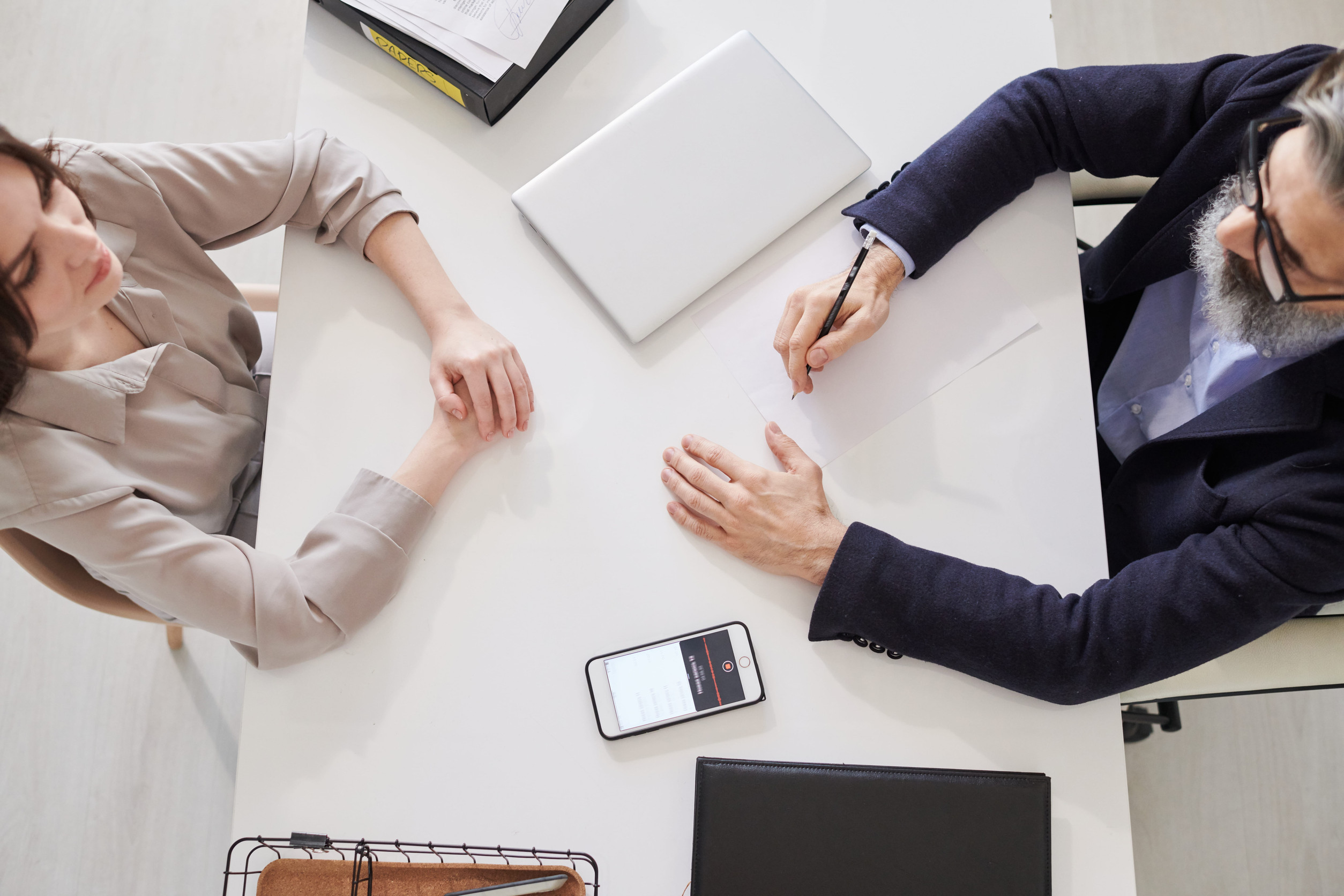 First Time Home Buyer Georgia: From above view shot of professional psychotherapist starting work with young woman sitting in front of him